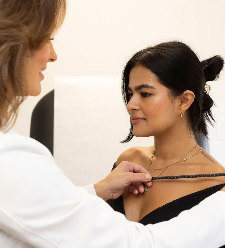 female plastic surgeon in Tampa, FL, Dr. Traci Temmen measuring a patient