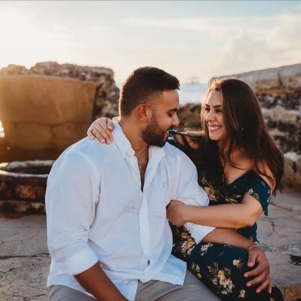 Couple enjoying a sunset on the beach.