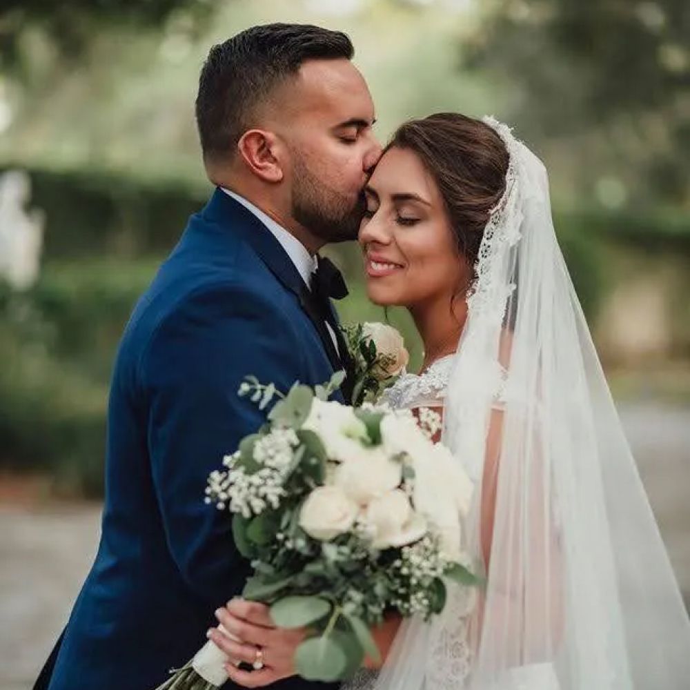 Happy bride and groom sharing affectionate moment.