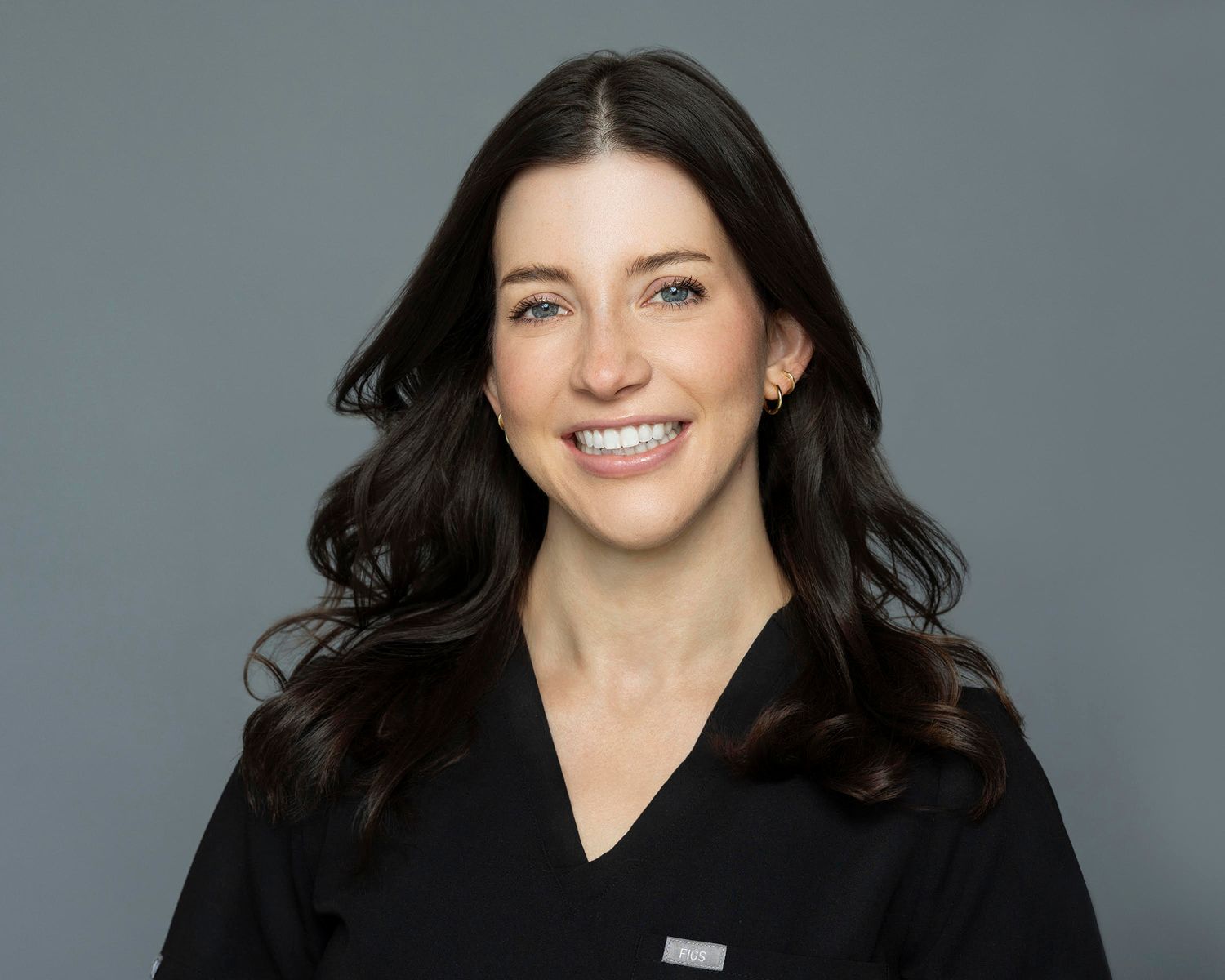 Professional headshot of a smiling nurse practitioner.