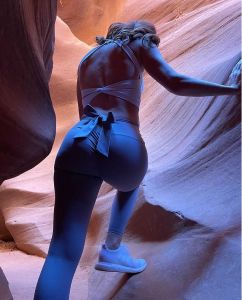 Person climbing in a colorful sandstone canyon.