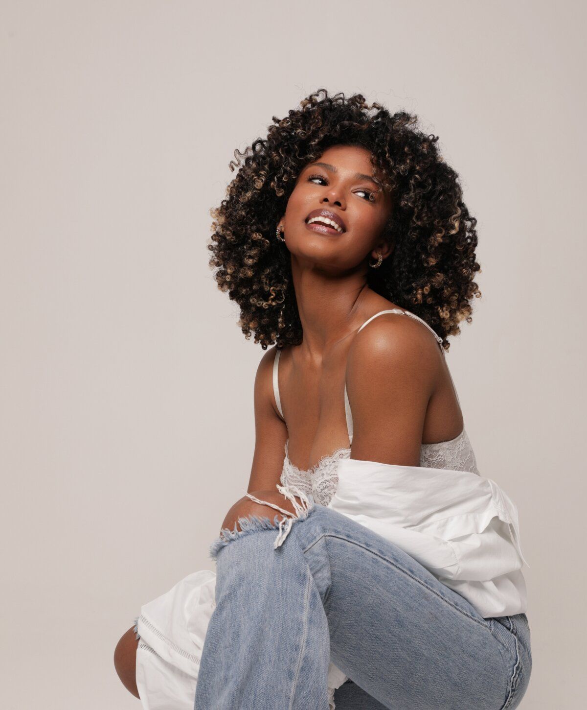 Woman with curly hair in casual outfit.