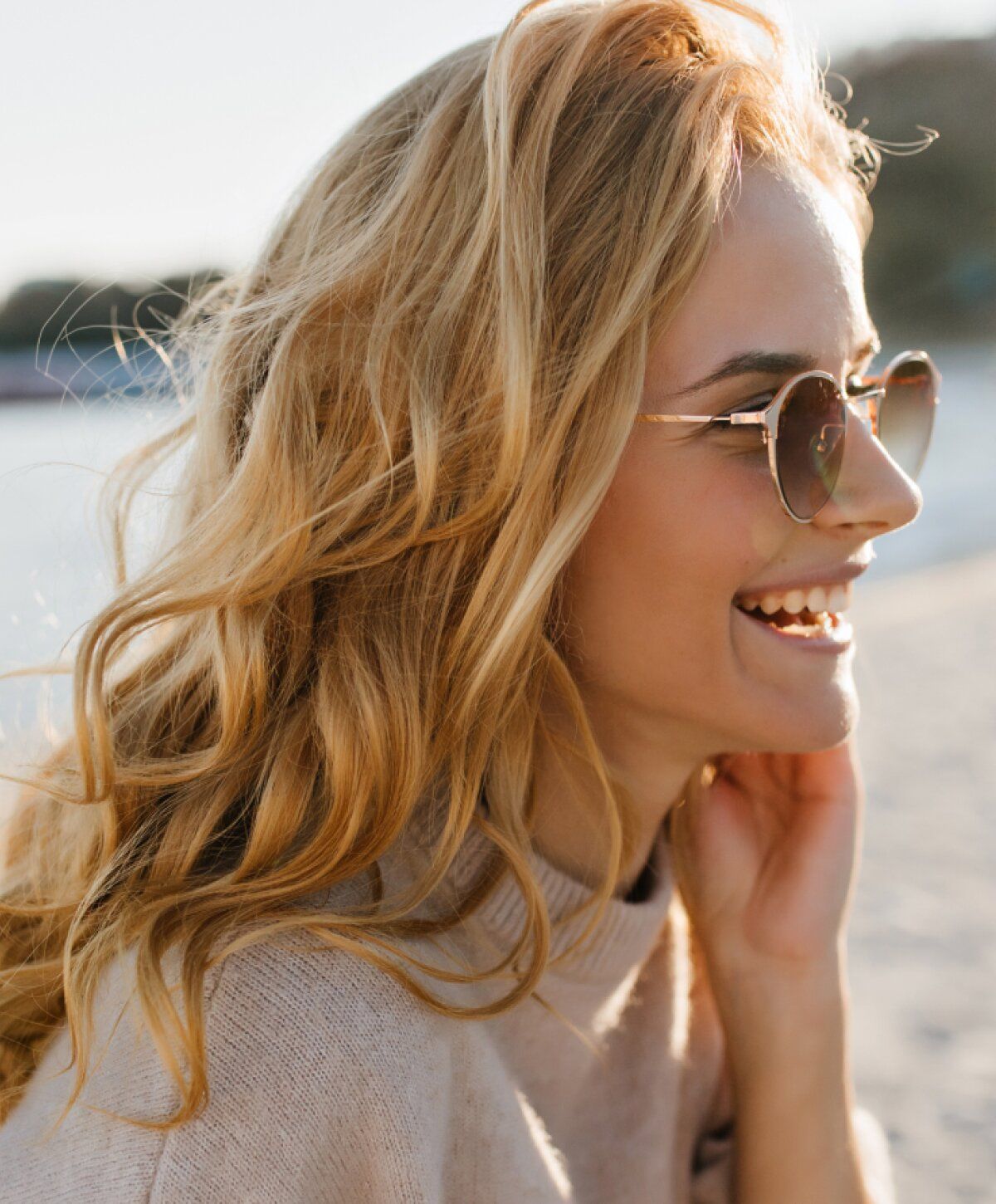 Smiling woman in a turquoise dress at dinner.