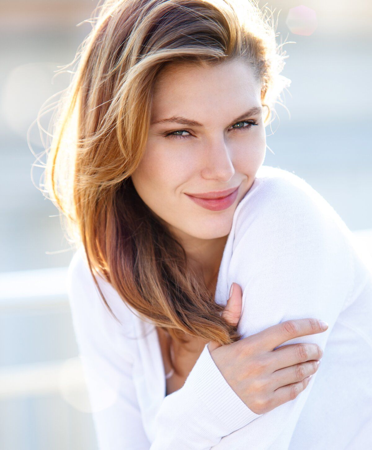 Smiling woman with long, wavy hair.