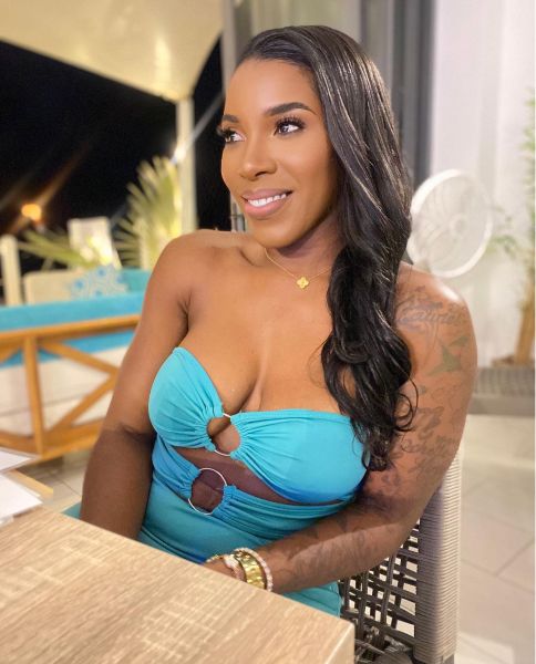 Tampa wrinkle treatments model in blue dress, smiling at a table.