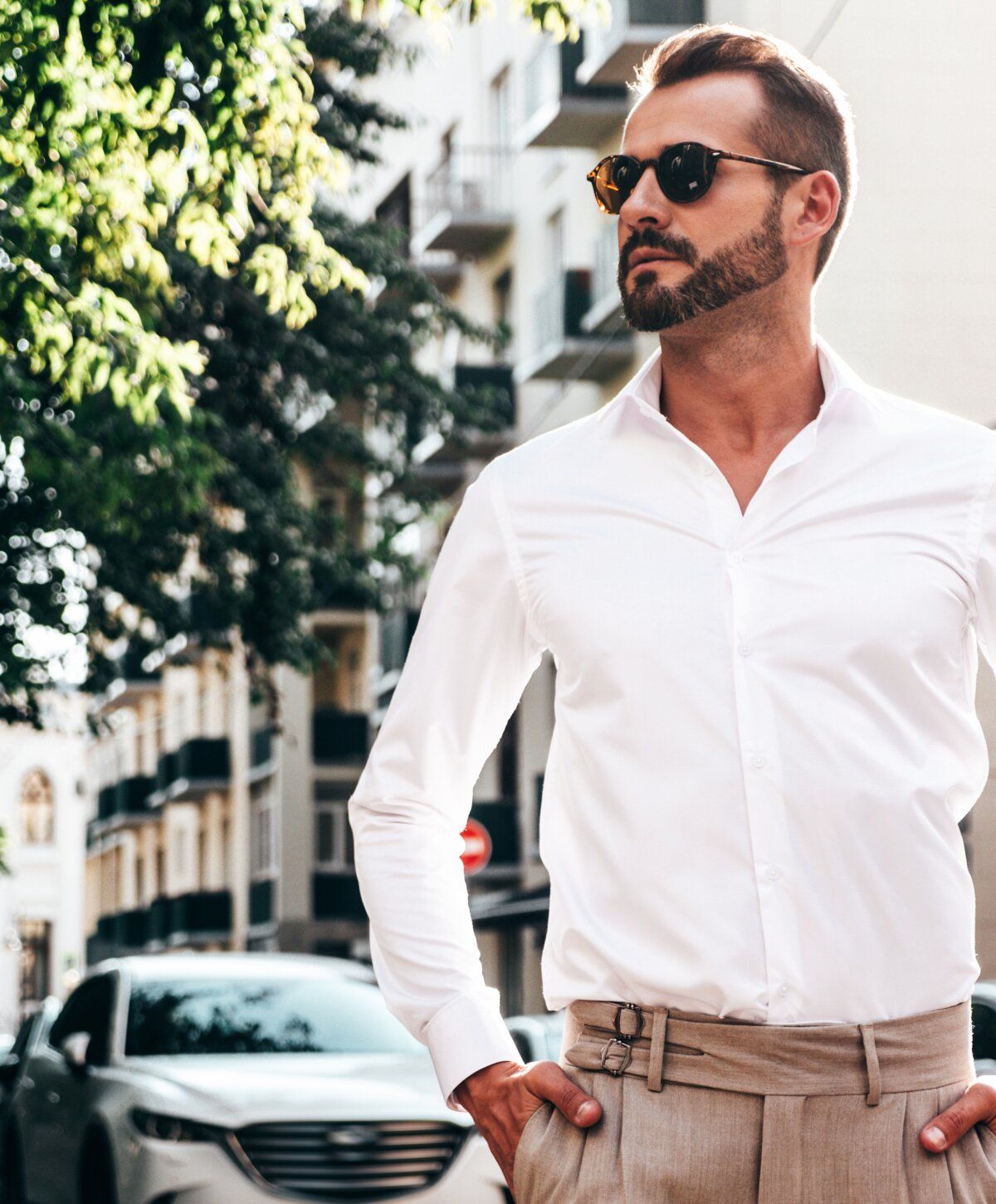 Woman in swimsuit by pool, wearing large hat.