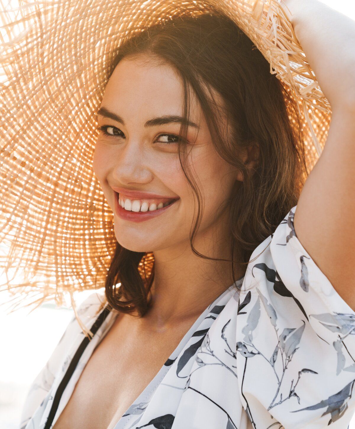 Woman with wet hair in bright sunlight.