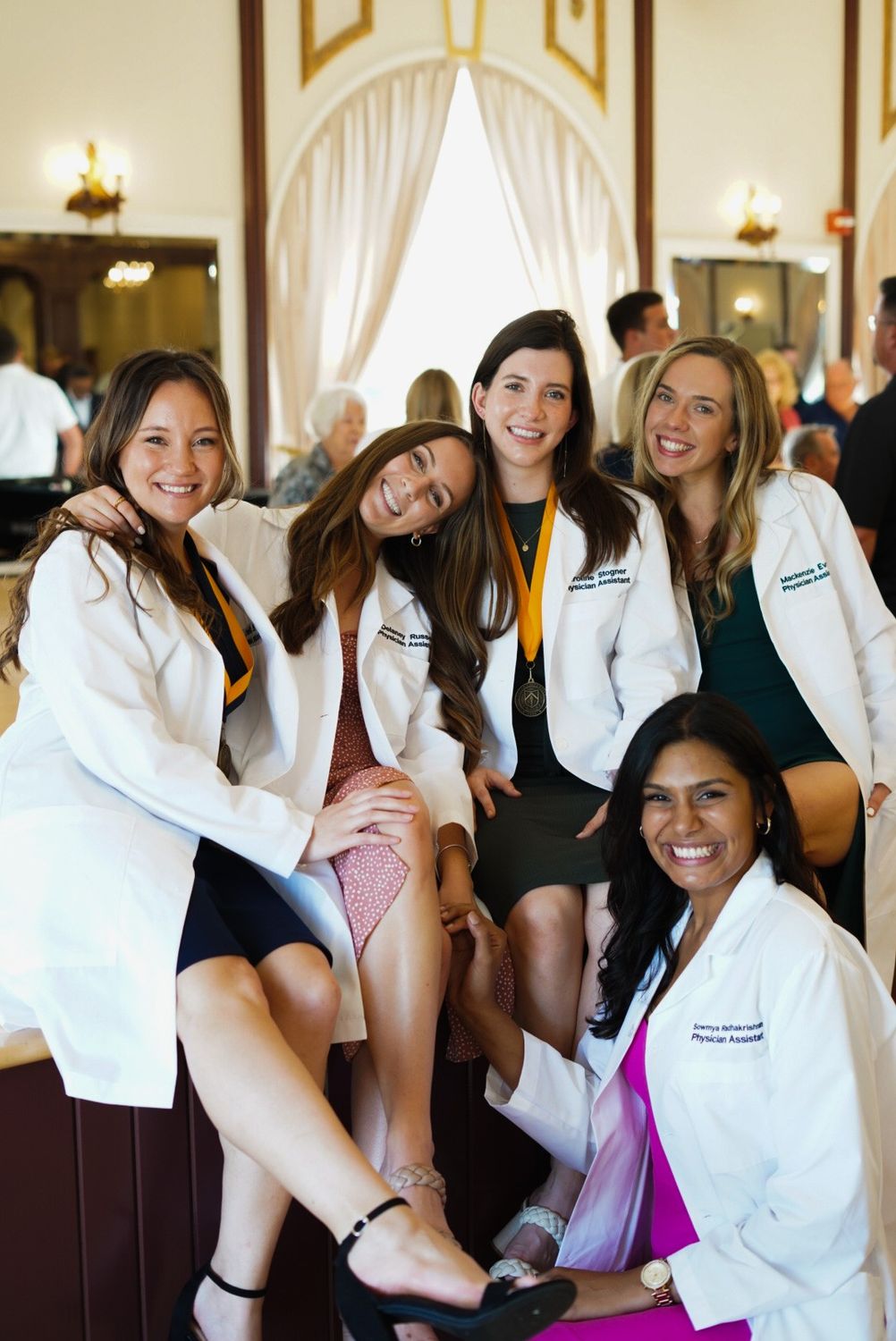 Child smiling under furniture with playful expression.